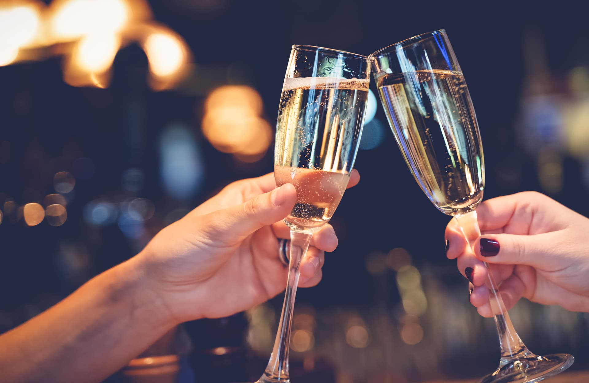 People clinking champagne glasses in celebration